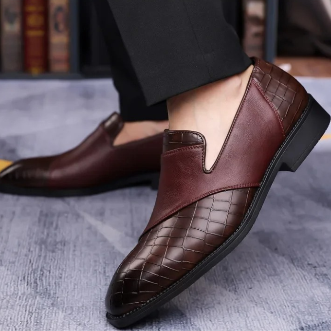 Detail of the croc-textured upper on a men's elegant slip-on loafer shoe