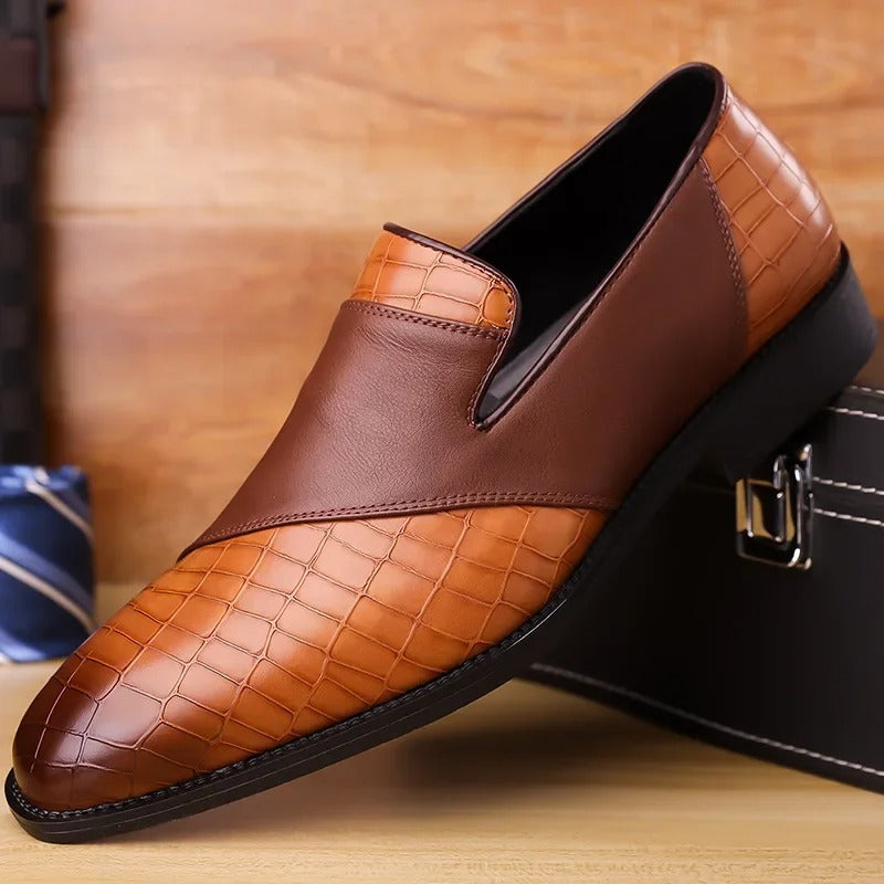 Close-up of men's black loafer with realistic croc-texture and polished finish