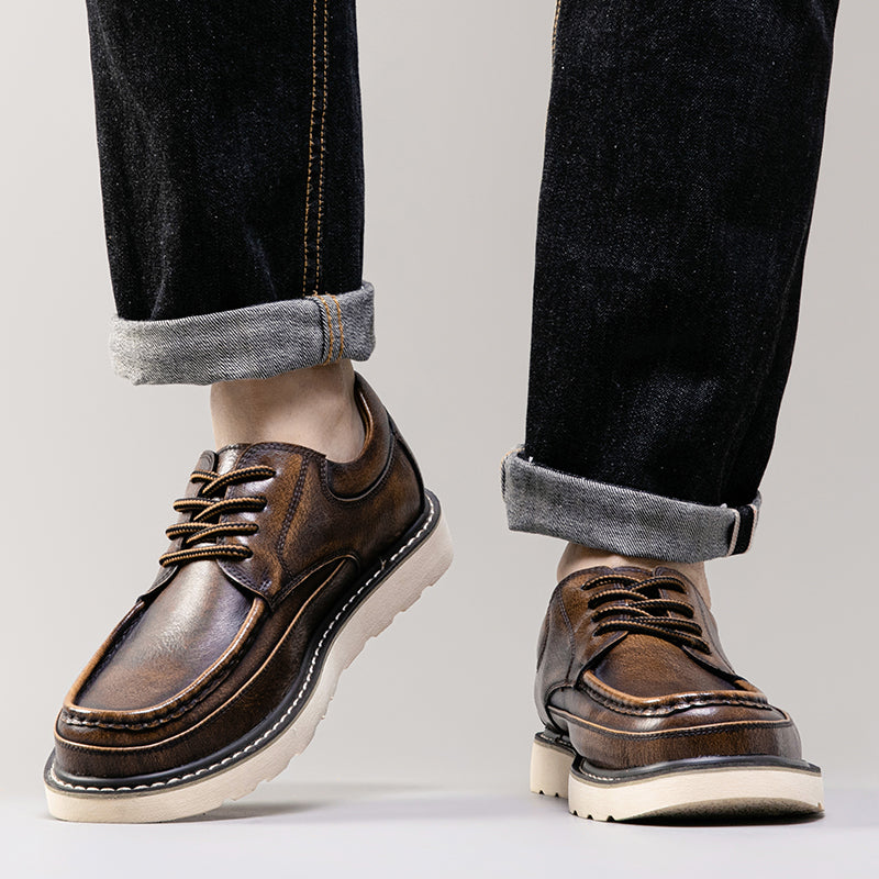 Men's casual brown boots on a wooden surface, ready for a day of comfortable wear