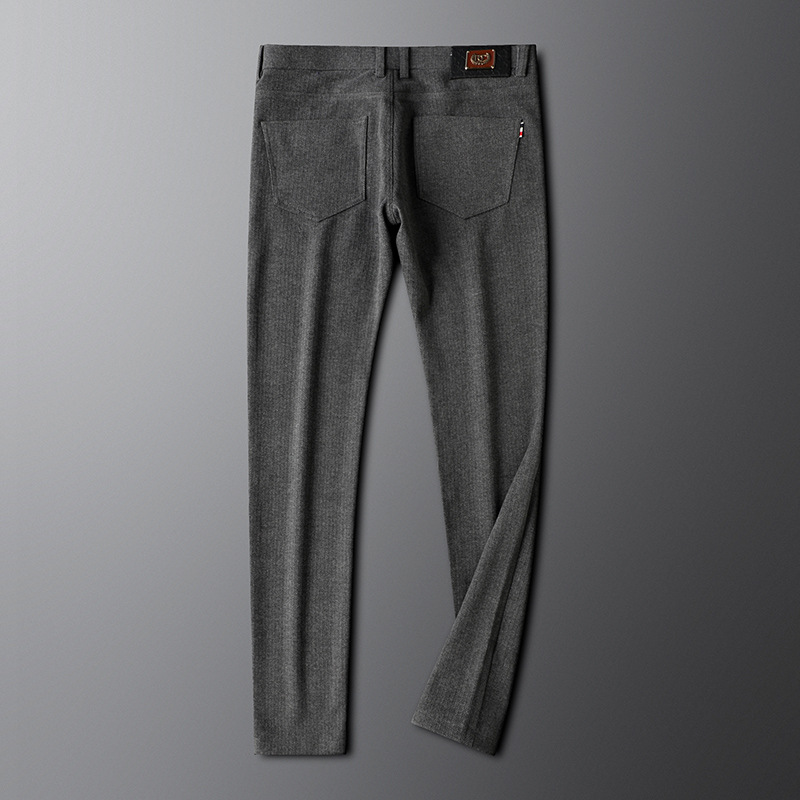 Man wearing smart casual khaki tailored trousers, paired with a white shirt, ideal for a contemporary look.