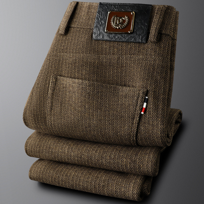 Detail of the waistband and button closure on men's gray tailored dress pants, emphasizing quality craftsmanship.