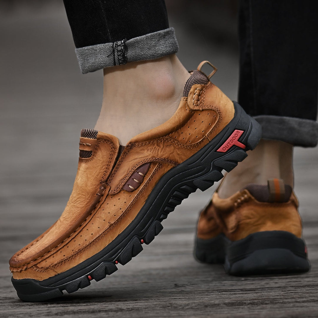 Black orthopedic men's boots worn with work trousers, comfortable for long shifts, slip-resistant.