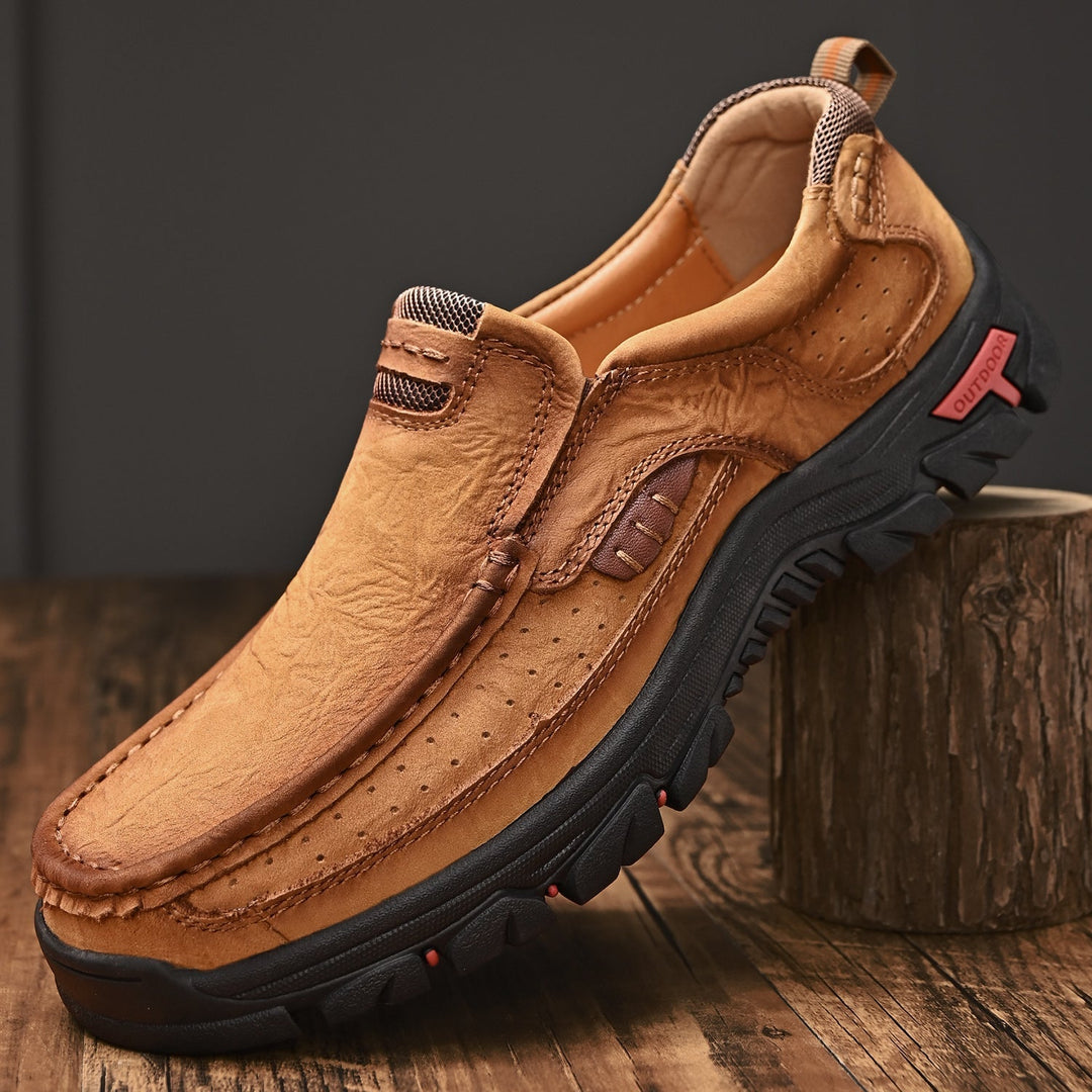 Close-up of khaki orthopedic men's transition boots, leather texture, comfortable sole details.