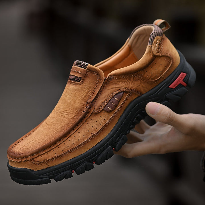 Men's orthopedic brown boots, comfortable sole, shown on a rustic wooden background, posture support.