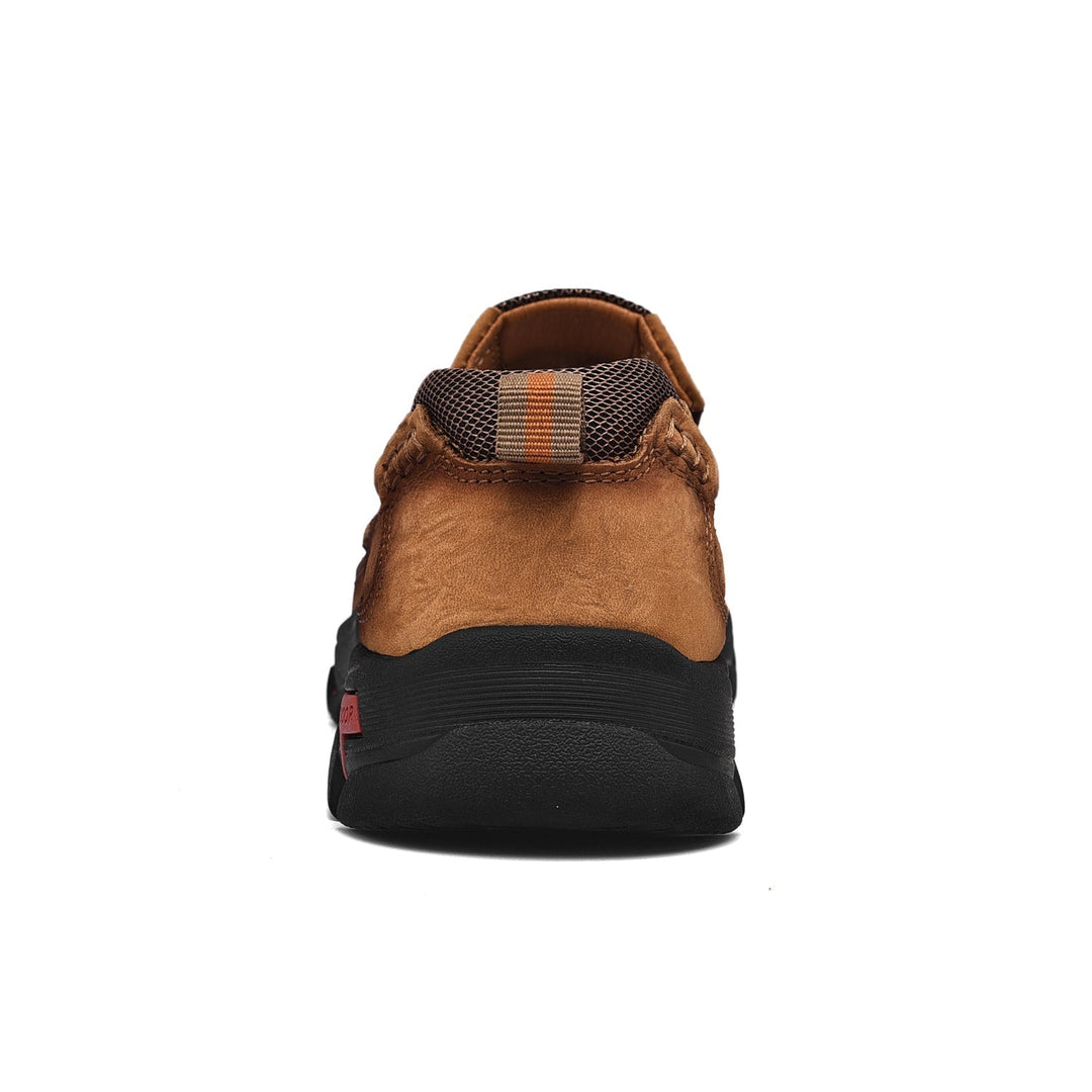 Black orthopedic men's footwear with comfortable sole, worn casually, emphasizing style and comfort.