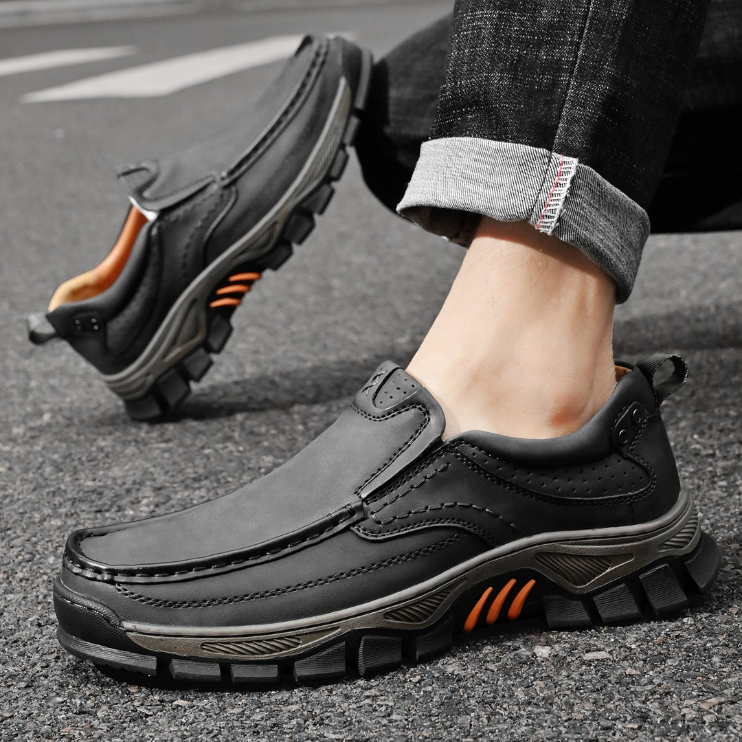 Orthopedic men's boots in a modern office, comfortable black footwear, dress casual