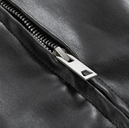 Close-up of a men's black leather bomber jacket, oversized cut, featuring rich leather texture.