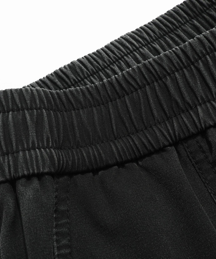 Man wearing Men's Performance Athletic Jogger Pants while jogging outdoors, emphasizing comfort & movement