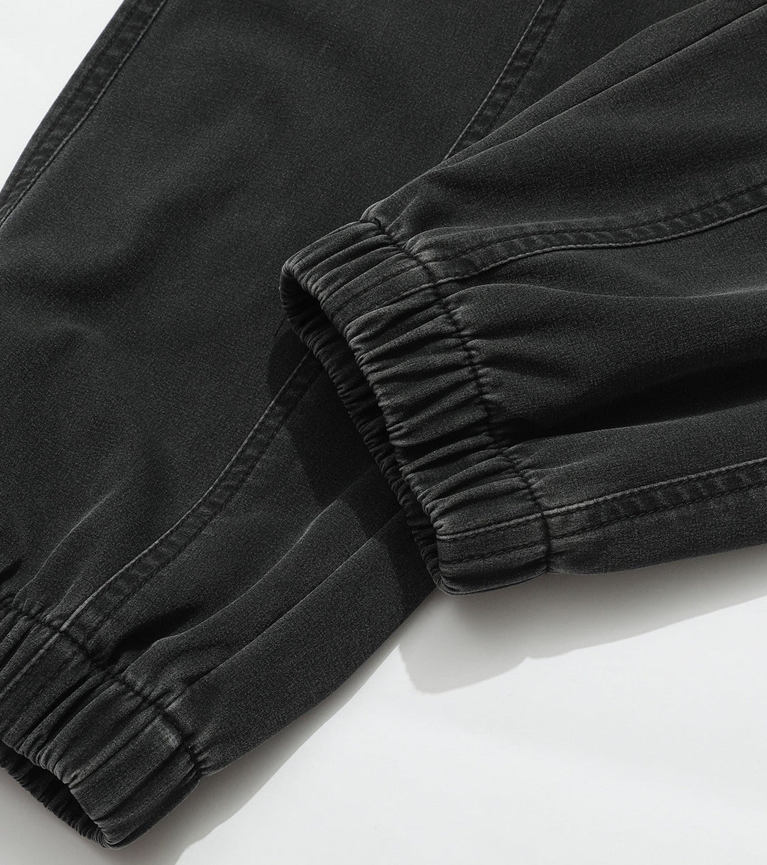 Studio shot: Men's navy performance joggers, folded neatly to show material & elastic waistband