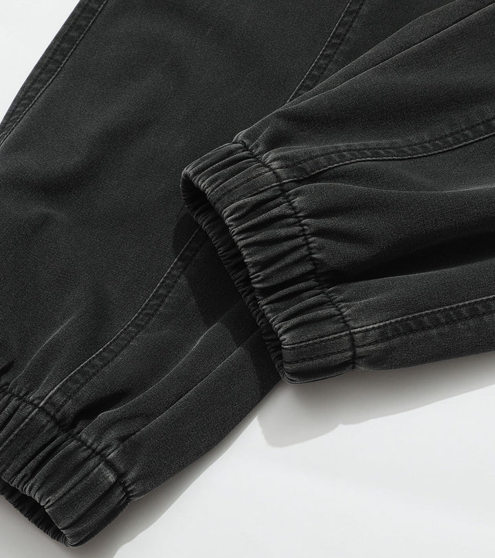 Studio shot: Men's navy performance joggers, folded neatly to show material & elastic waistband