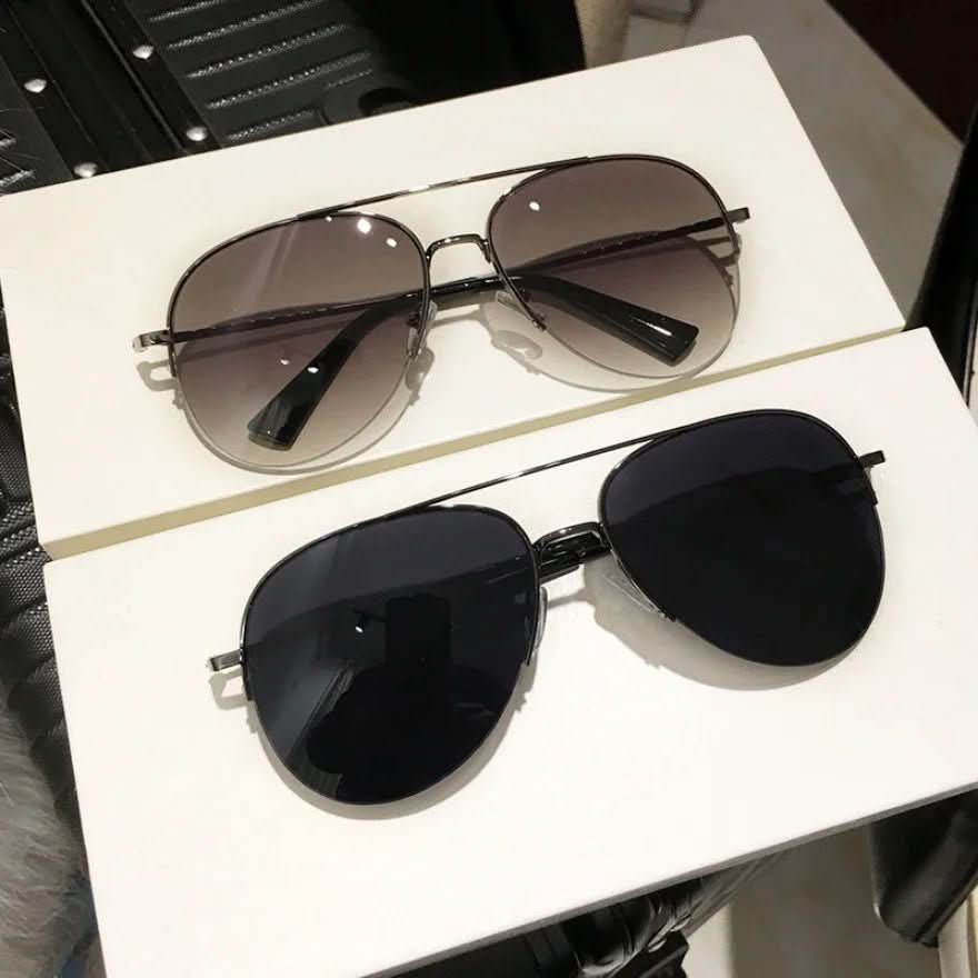 Stylish men's pilot sunglasses. Gradient lenses offer UV400 protection. Fashion accessory for outdoor adventures.