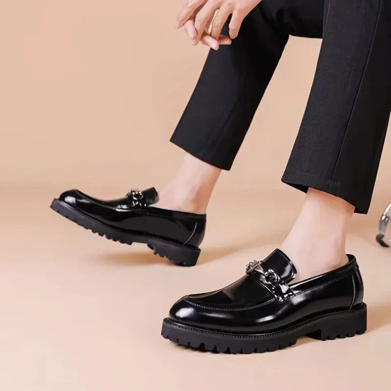Sleek men's polished black loafers with a distinctive silver metal bit. Essential formal slip-on dress shoes.