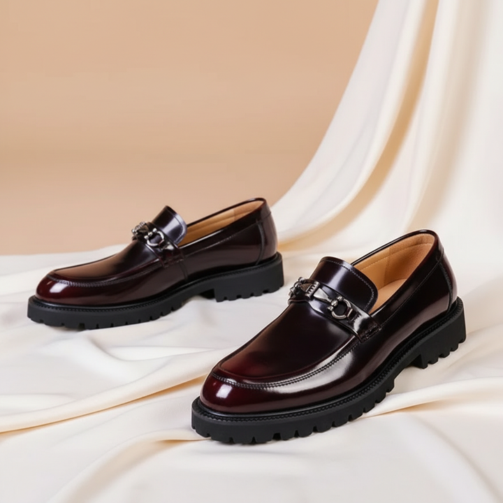 Top view of classic men's polished black loafers. Elegant slip-on footwear with a stylish metal bit.