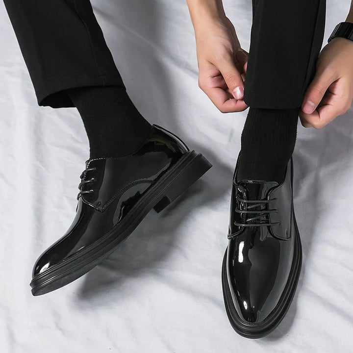 Men's formal black patent Derby shoes, featuring an open lacing system & polished finish for a sleek look.