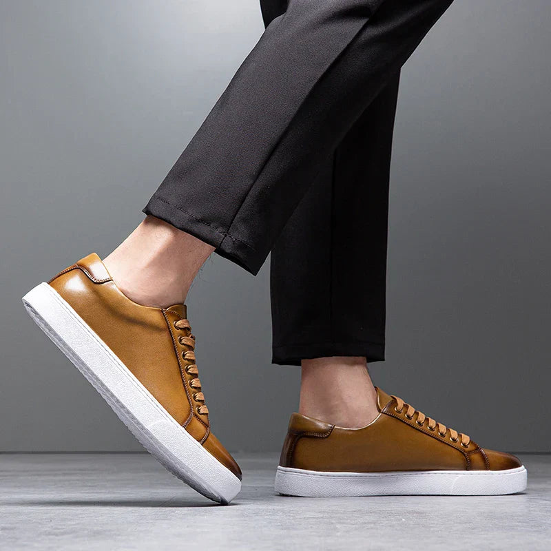 Men's white leather sneakers styled with chino pants, smart casual everyday shoes