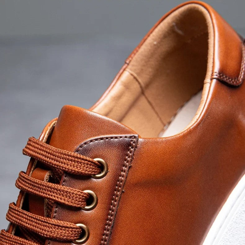 Top-down view of men's gray leather casual sneakers, minimalist design, comfortable fit