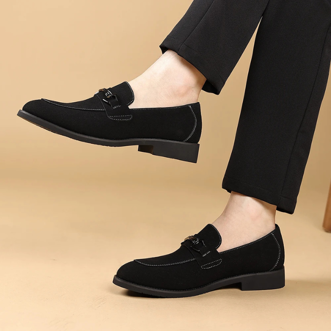 Image of a man walking in premium dark brown suede slip-on loafers, modern and chic.