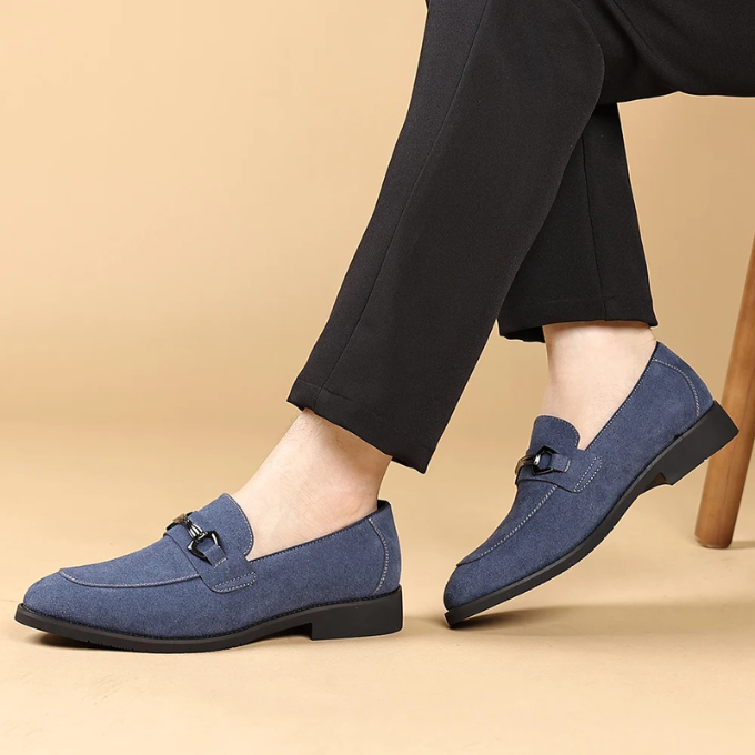 Detail of a man's foot wearing a premium brown suede slip-on loafer, comfort-focused.