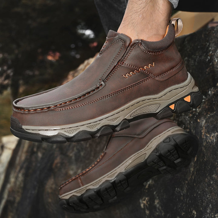 Underside of men's orthopedic slip-on shoes, showing the comfort sole and excellent grip, black leather