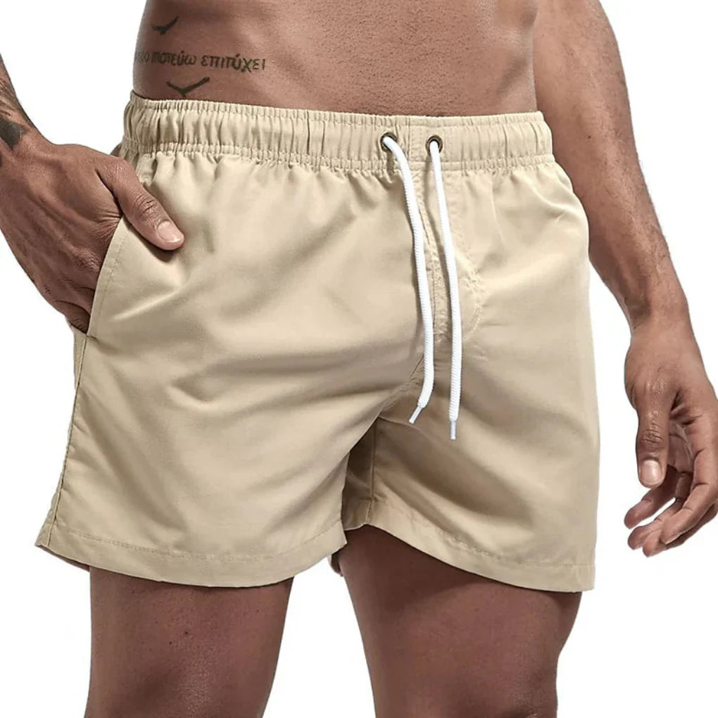 Stylish quick-dry men's performance swim shorts, essential beach & pool wear for summer vacations.