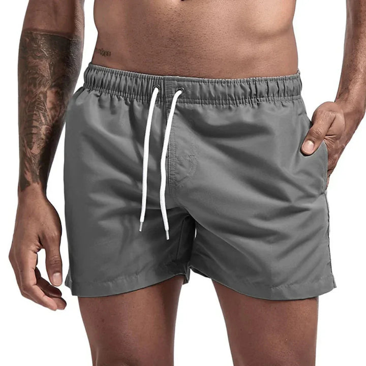 Men's athletic quick-dry swim shorts, designed for comfort & style in water sports and summer beachwear.