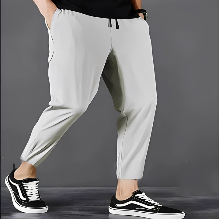 Active man wearing quick-dry stretch cargo hiking pants on a trail, perfect for outdoor adventures.