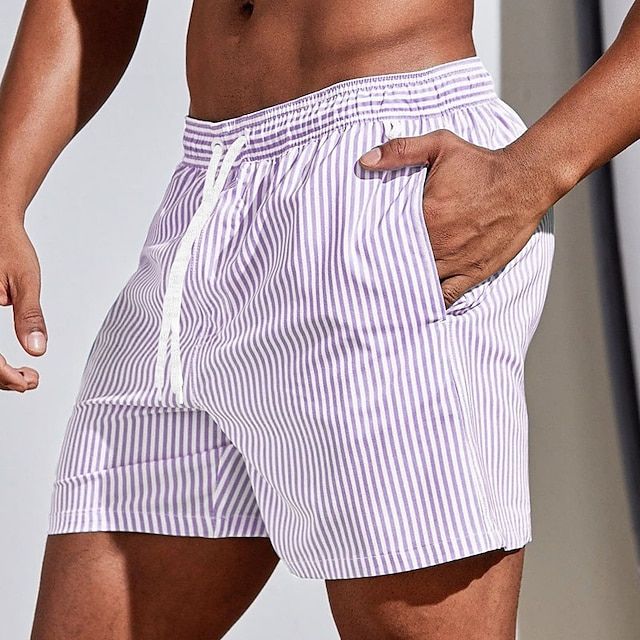 Modern men's striped swim shorts with quick-dry fabric and drawstring waist, a summer fashion essential.