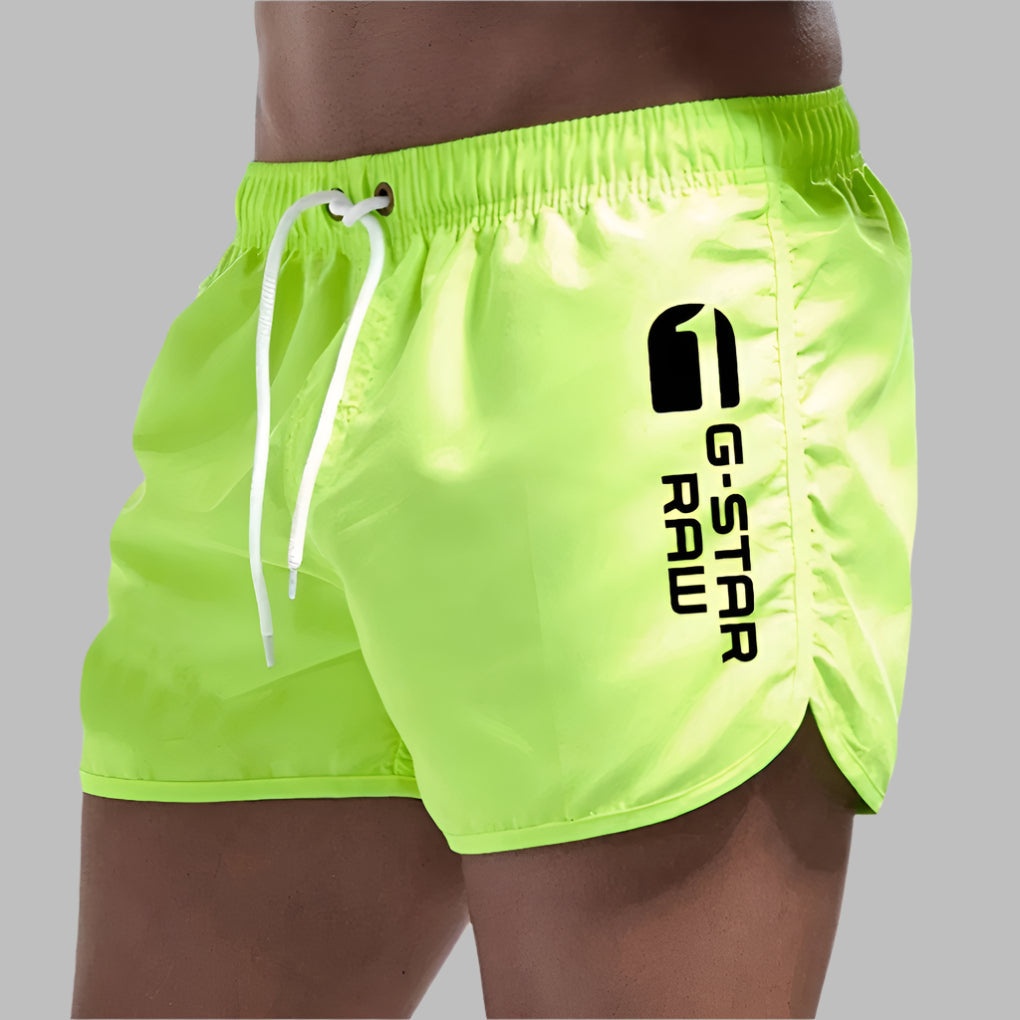 Performance men's quick-dry swim trunks. Solid color beach shorts perfect for active pool and beach activities.