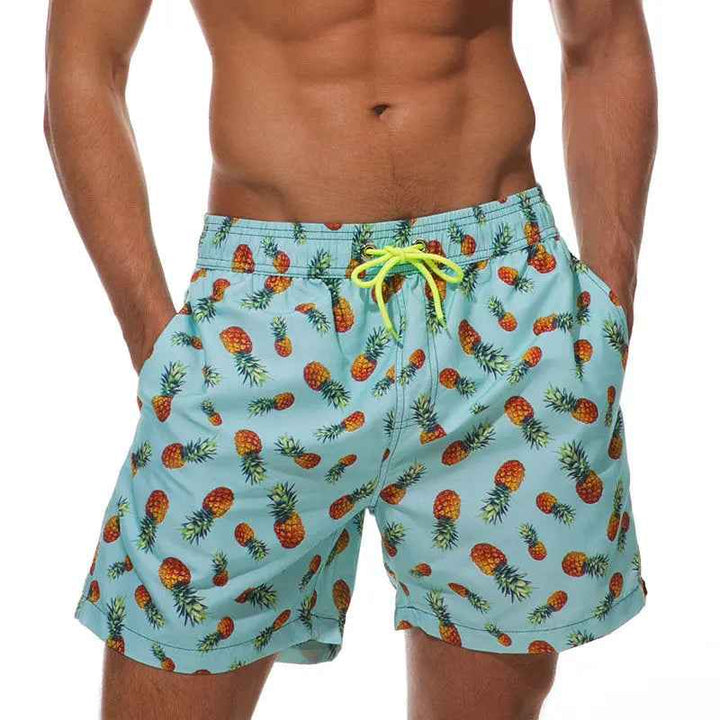 Men's quick-dry tropical print swim trunks for beach & pool, perfect for holidays.