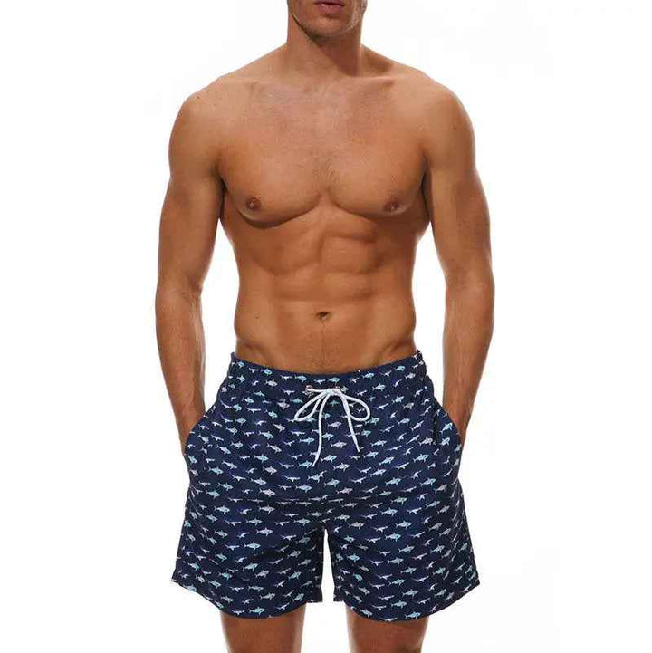 Quick-dry men's swim trunks with vibrant tropical print, perfect for pool or beach.