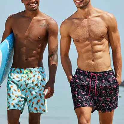 Stylish men's tropical print swim trunks, quick-drying with elastic waist for beach comfort.