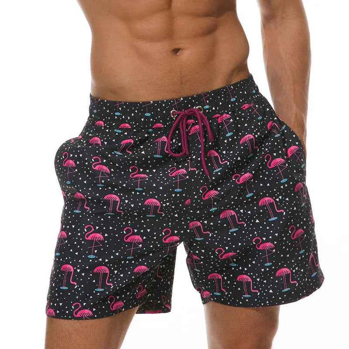 Vibrant tropical print men's swim trunks, quick-dry fabric for summer beach & pool.