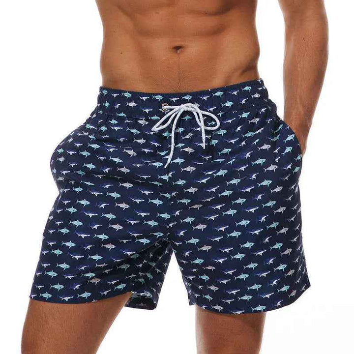 Men's quick-dry swimwear: tropical print swim trunks with elastic drawstring for beach.