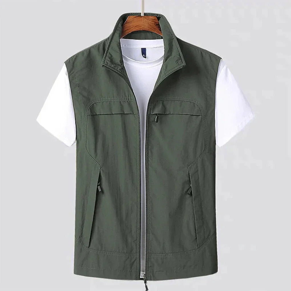 Man wearing a quick-dry sleeveless utility vest, perfect for hiking, travel, and outdoor activewear. Breathable design.
