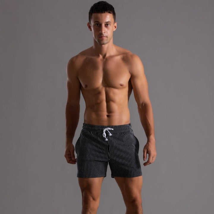 Close-up ripstop polyester on men's quick-drying swim shorts. Durable, stylish beachwear fabric.
