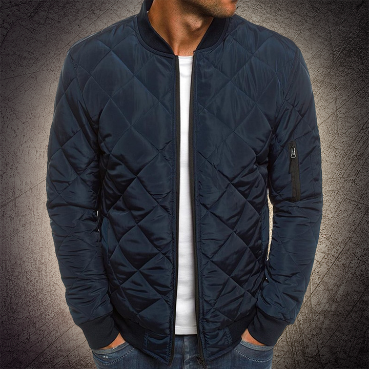 Side view of a men's lightweight quilted bomber jacket, showcasing its clean lines and modern design