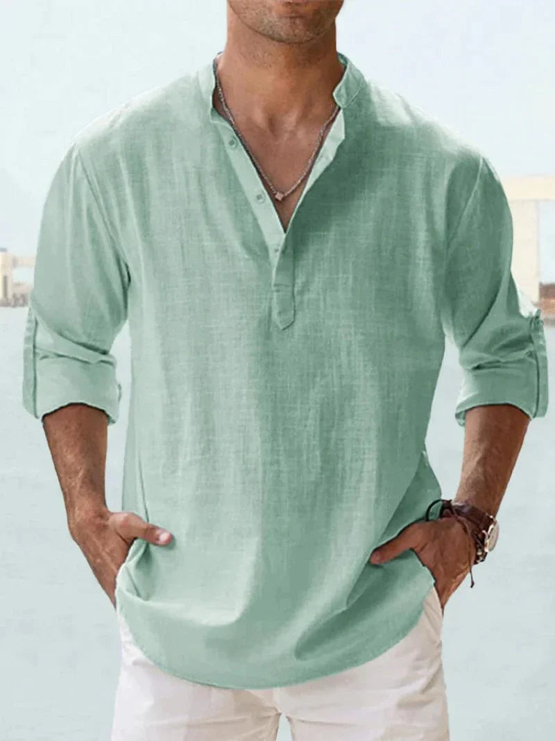 Detail shot of a men's relaxed fit long sleeve button-down summer shirt, showing fabric texture and buttons.