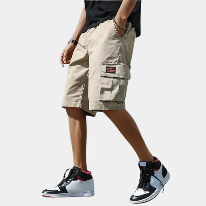 Practical men's utility cargo shorts with multiple pockets, ideal for comfortable summer travel and outdoor exploration.