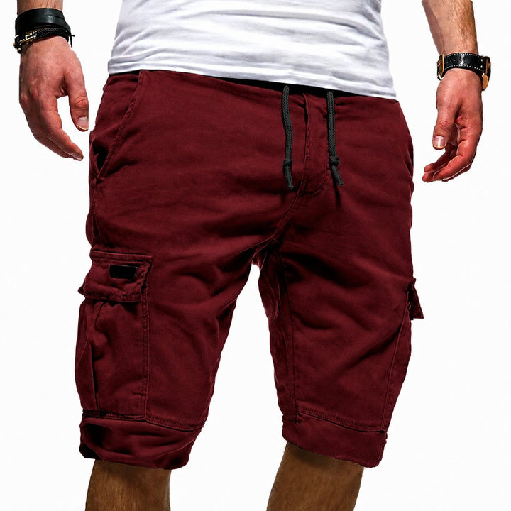 Man wearing men's relaxed fit cargo walking shorts, enjoying a summer outdoor adventure.