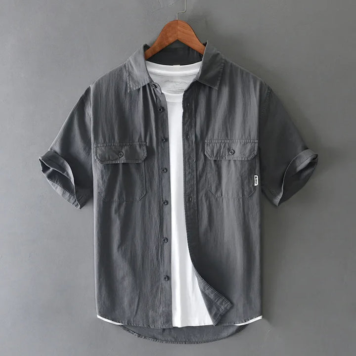 Modern men's casual shirt, relaxed fit short sleeve, button-up design. Versatile for workwear or everyday.