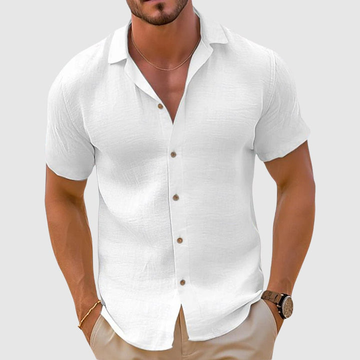 Versatile men's relaxed fit collared button-up shirt, ideal for warm weather, travel, or casual outings.
