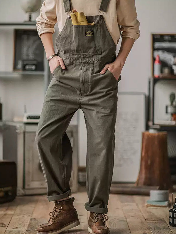 Dark green men's fashion overalls, relaxed fit for comfort & style. Features adjustable straps, a full-length jumpsuit.