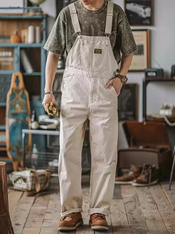 Men's utility overalls, relaxed fit for comfort. Practical bib pockets & adjustable straps, ideal for workwear style.