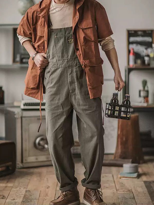 Dark green men's relaxed fit overalls, offering ultimate comfort with adjustable straps & front bib pockets. Jumpsuit style.