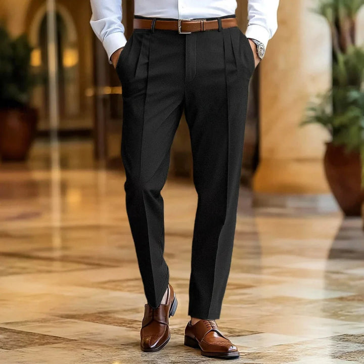 Relaxed fit men's summer trousers, tailored for breathable comfort. Lightweight pleated pants for versatile smart casual wear.