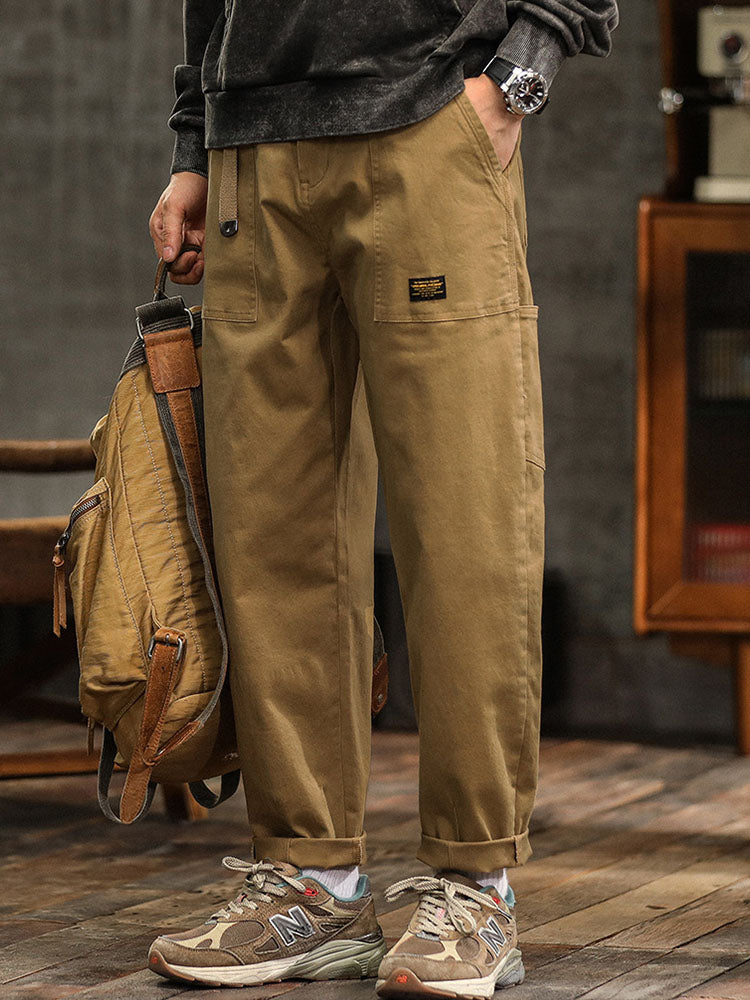 Green men's casual utility pants with a relaxed fit, great for an active lifestyle.
