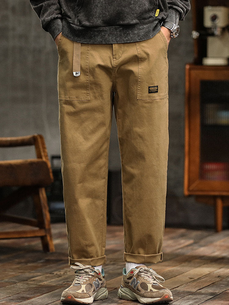 Green men's relaxed fit utility pants with practical pockets, ideal for versatile styling.