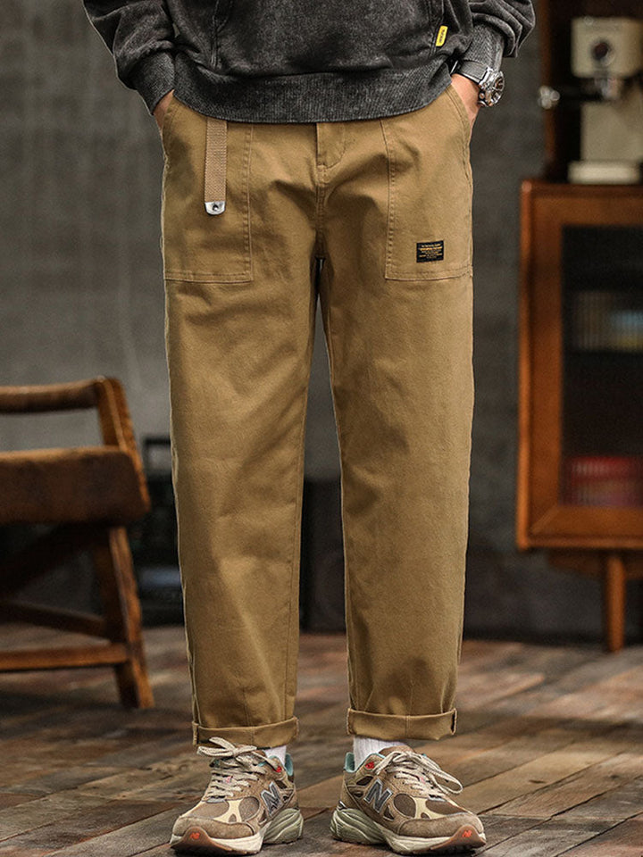 Green men's relaxed fit utility pants with practical pockets, ideal for versatile styling.