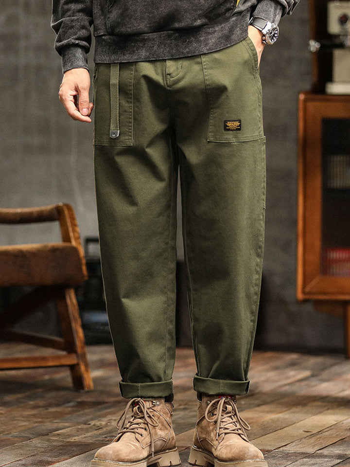 Side view of men's relaxed fit utility cargo pants, highlighting pocket details.