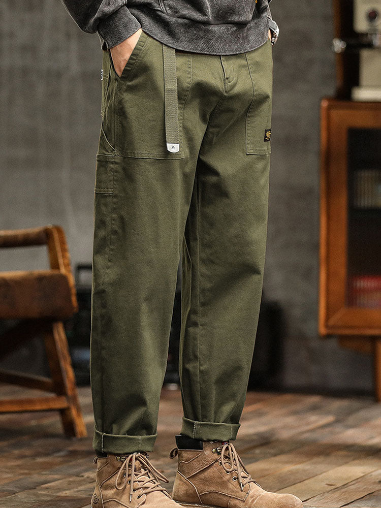 Close-up of fabric on men's relaxed fit utility pants, emphasizing durability & comfort.